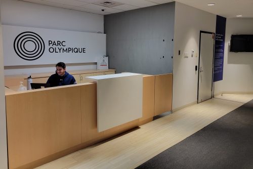 Un agent d'accueil souriant à l'entrée des bureaux relocalisés de l'INS Québec.